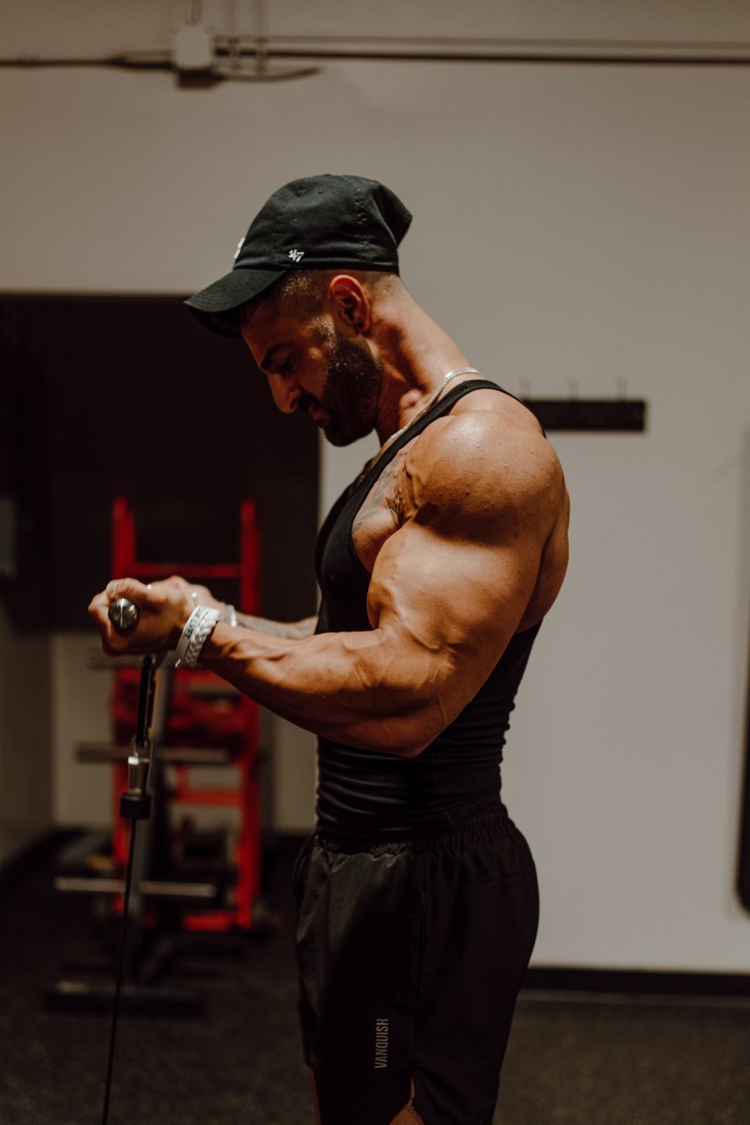 Coach flexing during a cable curl